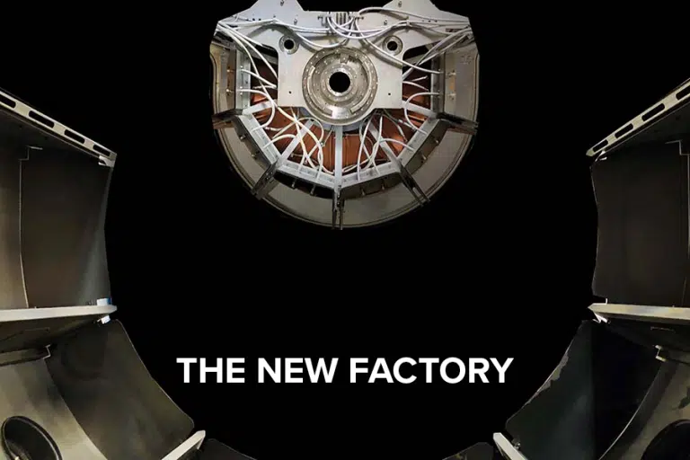Close-up of a sputter machine. White text with "The new factory".
