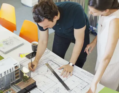 Architect drafting blueprints in office